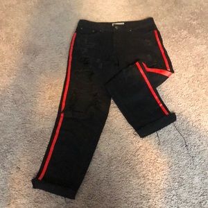 Distressed black jeans with red side stripes